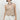 Women’s beige tailored halter vest with V-neckline, button front and welt pocket details.