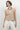 Women’s beige tailored halter vest with V-neckline, button front and welt pocket details.