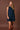 Women's dark wash denim sleeveless mini dress featuring a collared neckline, button-front closure, and front flap pockets.