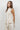 Women’s sleeveless linen blend top featuring a self-tie neckline, subtle vertical stripes, and a tailored silhouette. Matching pants sold separately.