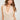 Women’s sleeveless ivory cowl neck blouse with pearl-inspired embellishments and a soft draped silhouette.