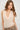 Women’s sleeveless ivory cowl neck blouse with pearl-inspired embellishments and a soft draped silhouette.
