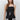 Women’s black sleeveless button-front top with white lace trim, square neckline and fitted waist.