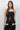 Women’s black sleeveless button-front top with white lace trim, square neckline and fitted waist.