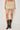 Women's sand mini skirt with macramé fringe trim and neutral woven fabric.