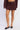 Women’s burgundy pinstripe tailored mini skirt with coordinating slim belt and silver buckle.