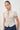 Women's smocked plaid blouse featuring puff sleeves, a tie-front neckline, ruffle collar, and peplum hem.