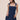 Women’s dark wash denim mini dress featuring a square neckline, wide shoulder straps, fitted bodice, and front patch pockets.