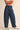 Women’s dark wash barrel leg jeans with allover blue polka dots and curved seam detailing.