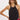 Women’s black embroidered halter top featuring tonal floral embroidery, scalloped hem, and sleeveless high neckline.