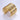 Gold bracelet on a light gray background