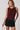 Women's burgundy sleeveless knit top featuring a draped crew neckline, ruched waist, and fitted silhouette.