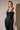 Women’s black satin sleeveless top with sheer floral lace neckline and lace bust detailing.