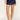 Person wearing a denim skirt on a plain background