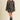 Women’s brown polka dot two-piece set featuring a button-front collared jacket and coordinating high-waisted mini skirt.
