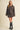 Women’s brown polka dot two-piece set featuring a button-front collared jacket and coordinating high-waisted mini skirt.