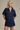 Woman wearing a denim outfit on a beige background