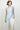 Women’s powder blue satin halter top with eyelash lace trim and asymmetric draped hem.