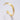 Gold bracelet on a light gray background