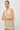 Women's sand halter top with draped neckline and macramé fringe hem.