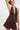 Women’s chocolate brown halter cami with lace trim, button front detail, deep V-neckline, and flowy babydoll silhouette.