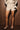 Women’s cream and taupe striped high-waisted shorts with wide wrap tie waistband.