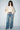 Women’s ivory high neck blouse with dramatic split sleeves, ruffled cuffs and flowy silhouette.