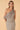 Women’s brown and cream gingham one-shoulder top with asymmetric draped overlay detail.