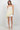 Woman wearing a white lace top and shorts on a white background