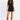 Women’s black denim two-piece set featuring a sleeveless zip-front vest with keyhole neckline and matching high-waisted mini skirt.