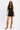 Women’s black denim two-piece set featuring a sleeveless zip-front vest with keyhole neckline and matching high-waisted mini skirt.
