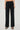 Women's black wide leg pants with silver grommet fold-over waistband in soft stretch fabric.