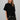 Women's black oversized tunic top featuring a soft knit bodice, polka dot contrast hem, and delicate lace trim.